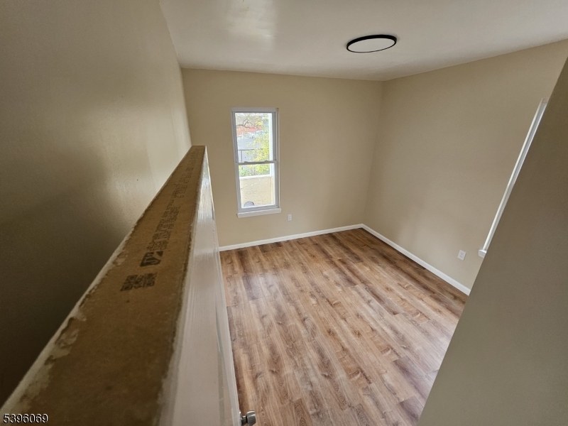 518 East 23rd Street, Unit 1F Paterson, NJ 07514 - Photo 3 of 4 wooden floor in an empty room with a window