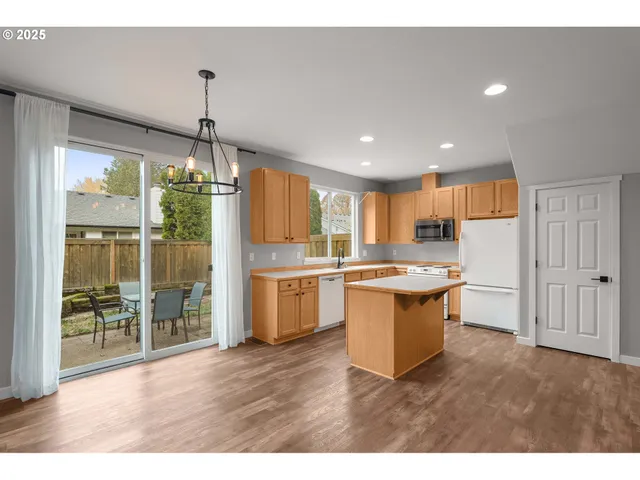a kitchen with a refrigerator and a sink