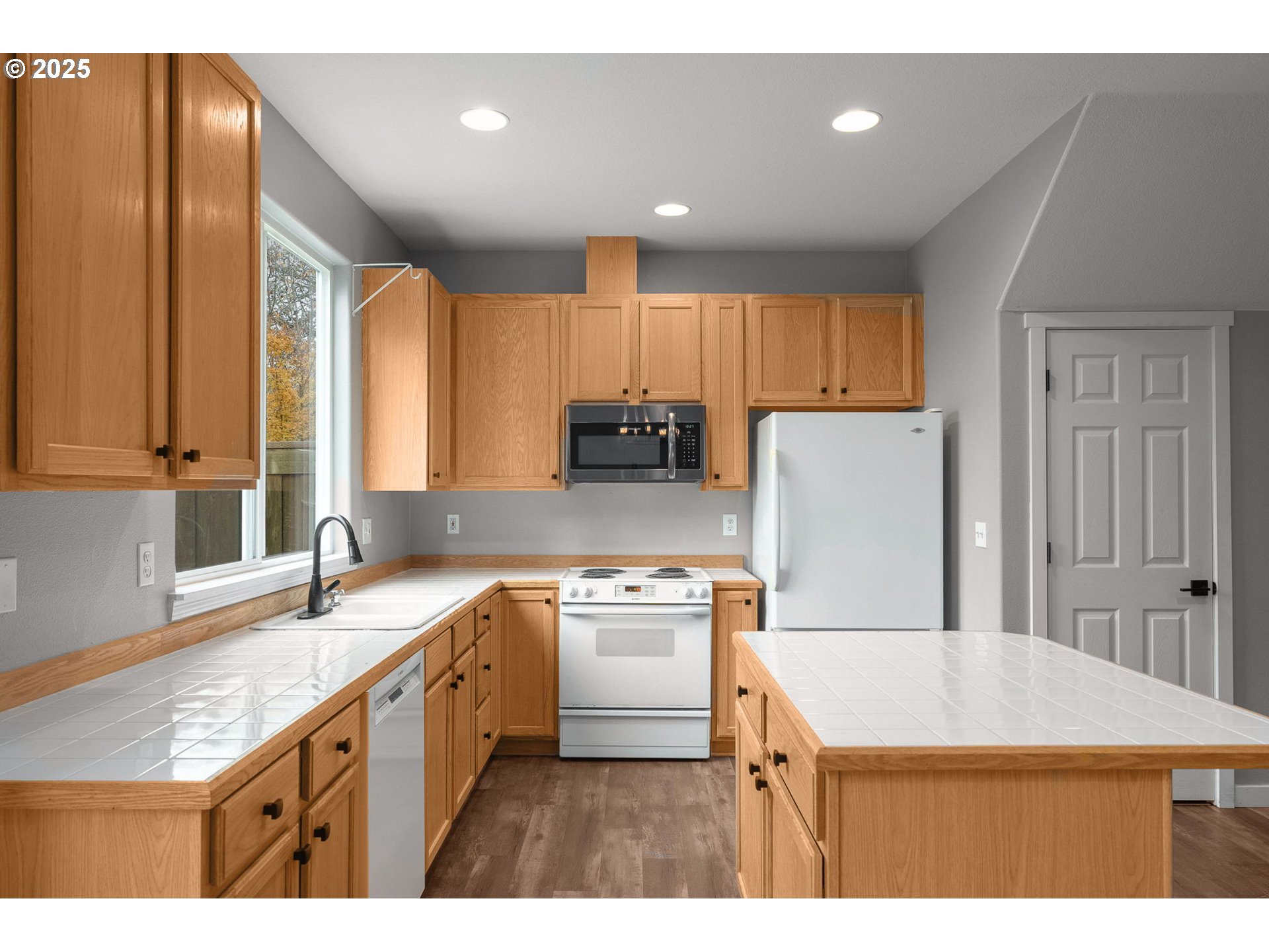 3255 Southwest 179th Terrace Beaverton, OR 97003 - Photo 14 of 38 a kitchen with kitchen island granite countertop a sink appliances and cabinets