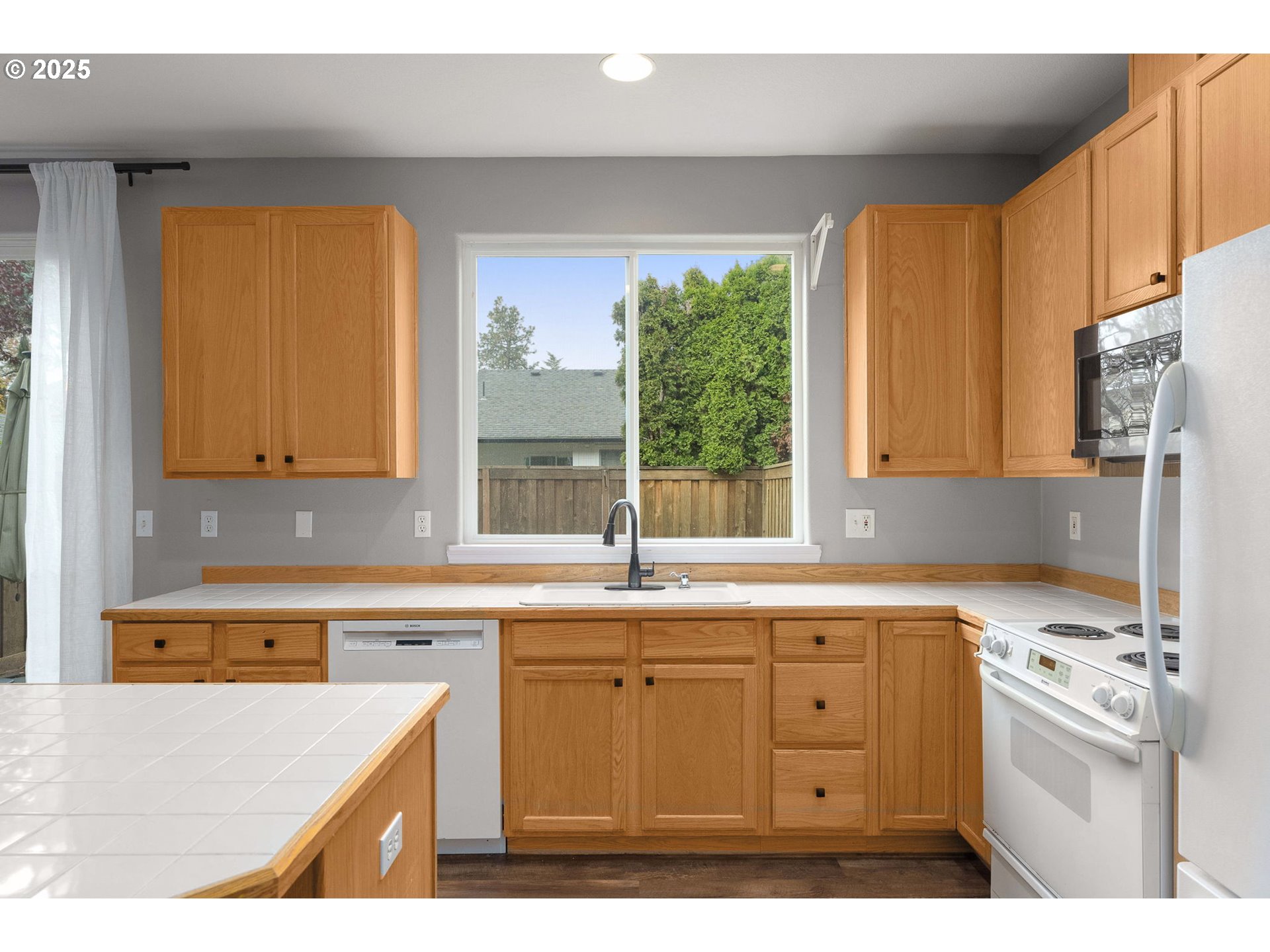 3255 Southwest 179th Terrace Beaverton, OR 97003 - Photo 15 of 38 a kitchen with a sink a stove and cabinets