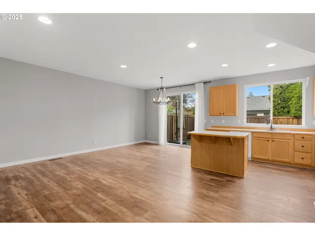 a kitchen with stainless steel appliances granite countertop a stove a sink and a large refrigerator