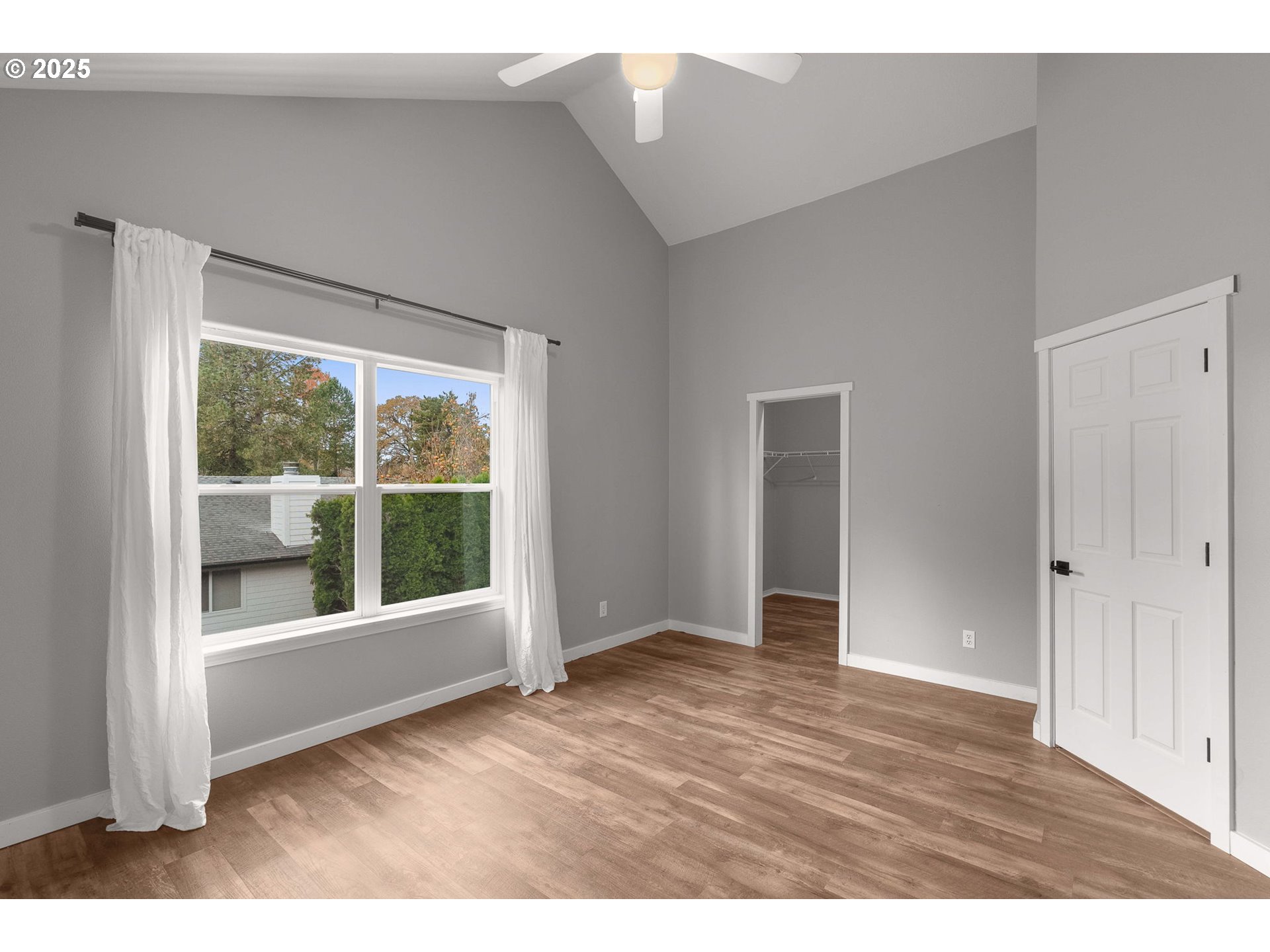 3255 Southwest 179th Terrace Beaverton, OR 97003 - Photo 21 of 38 a view of an empty room with wooden floor and windows