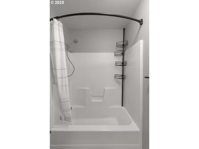 a bathroom with a glass shower door
