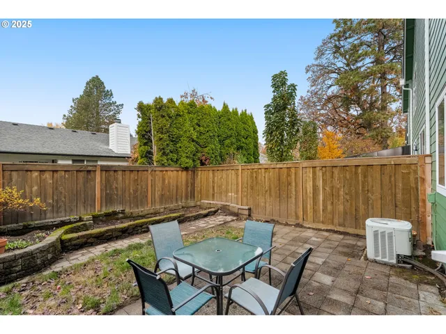 a backyard of a house with table and chairs