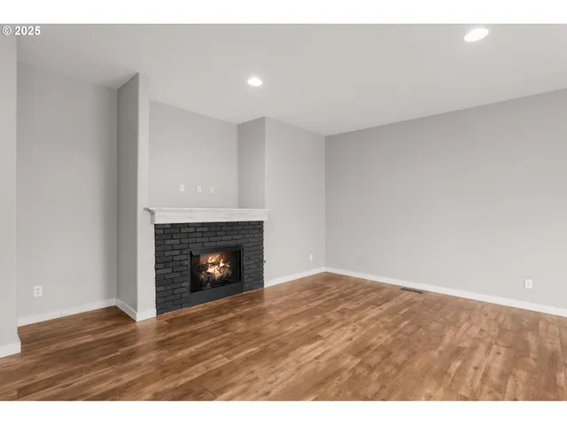 a view of an empty room with a fireplace