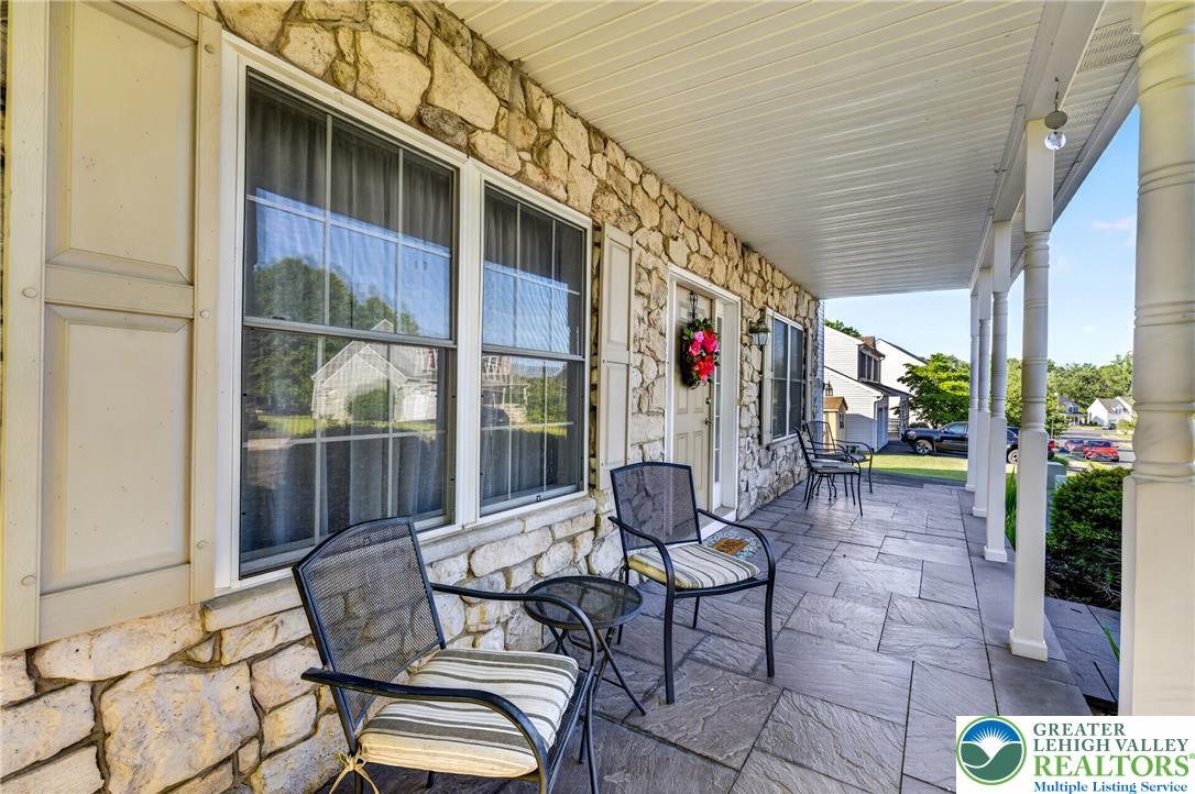 1702 Red Bud Road Quakertown, PA 18951 - Photo 3 of 68 A welcoming front porch features natural stone siding and a flagstone patio.