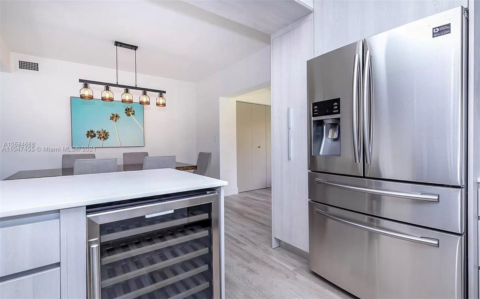332 Southwest 20th Road Miami, FL 33129 - Photo 11 of 23 a kitchen with kitchen island a counter top a refrigerator and a sink