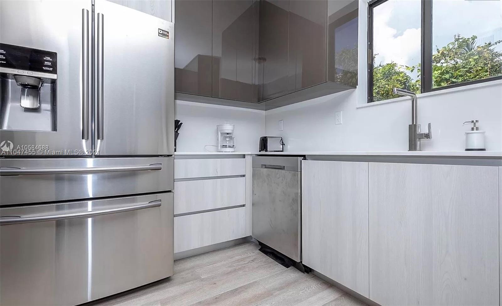 332 Southwest 20th Road Miami, FL 33129 - Photo 12 of 23 a kitchen with appliances cabinets and a wooden floor