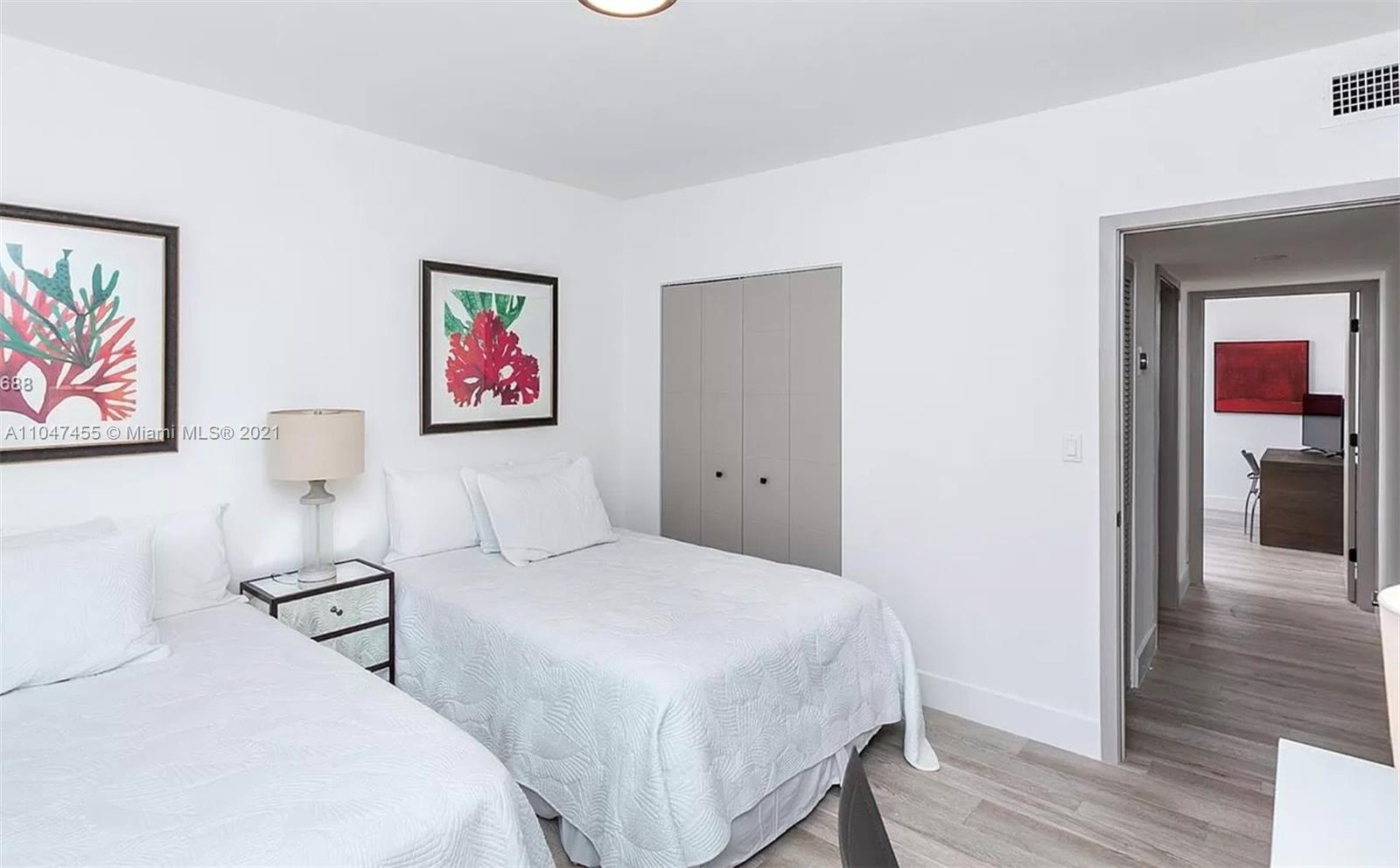 332 Southwest 20th Road Miami, FL 33129 - Photo 14 of 23 a bedroom with two beds and a painting on the wall