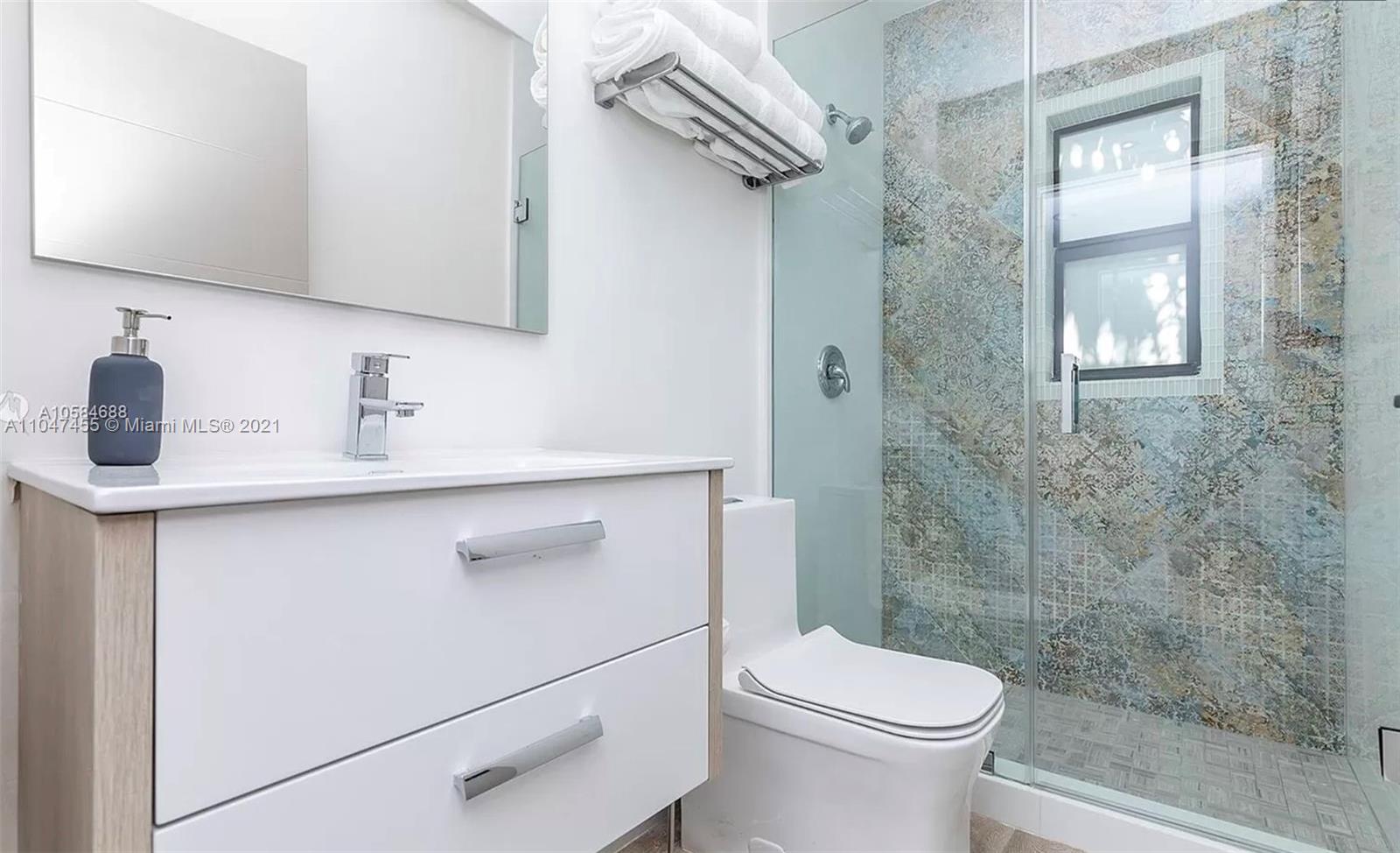 332 Southwest 20th Road Miami, FL 33129 - Photo 15 of 23 a bathroom with a sink a toilet and shower