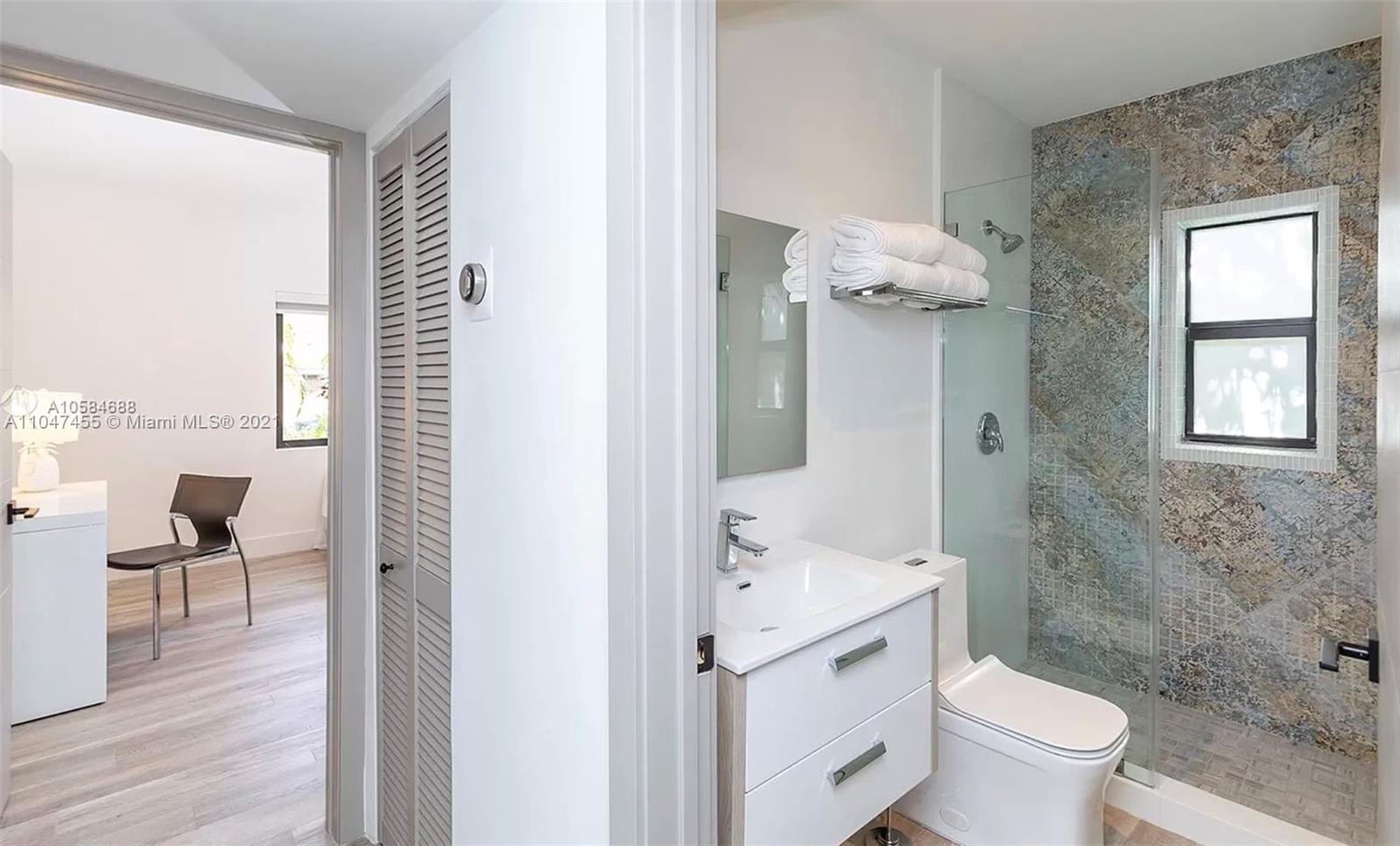 332 Southwest 20th Road Miami, FL 33129 - Photo 18 of 23 a bathroom with a toilet sink and mirror