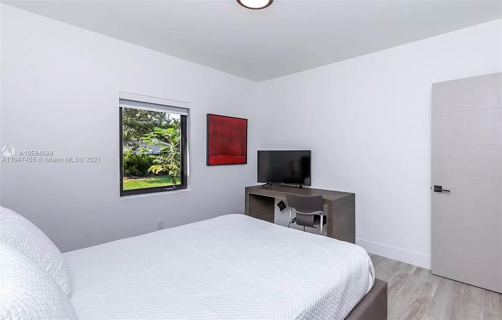 332 Southwest 20th Road Miami, FL 33129 - Photo 21 of 23 a bedroom with a bed and a flat screen tv