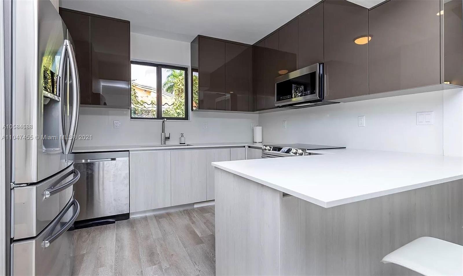 332 Southwest 20th Road Miami, FL 33129 - Photo 9 of 23 a kitchen with stainless steel appliances granite countertop a sink and a microwave