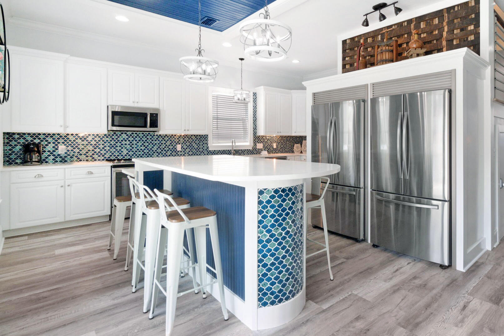 29 Sarasota Street Miramar Beach, FL 32550 - Photo 19 of 66 a kitchen with stainless steel appliances a dining table chairs refrigerator and sink