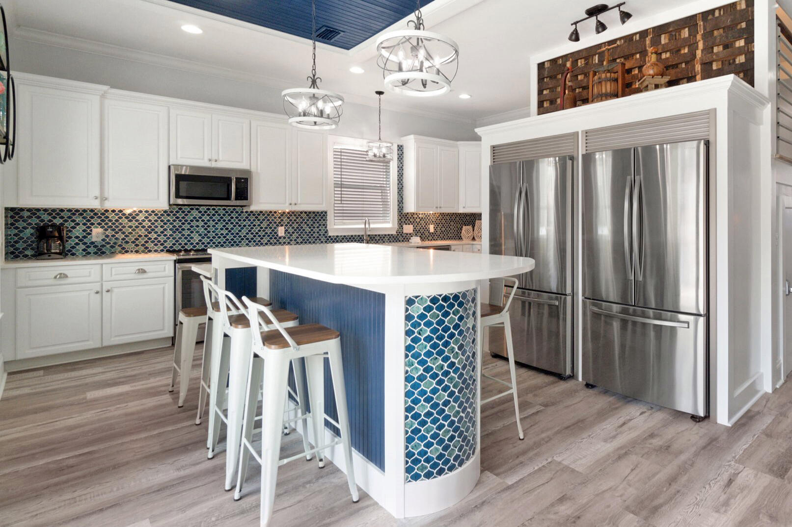 29 Sarasota Street Miramar Beach, FL 32550 - Photo 20 of 66 a kitchen with stainless steel appliances a dining table chairs refrigerator and cabinets