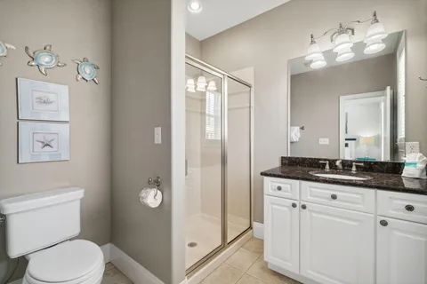 a bedroom with a bed and a flat tv screen on dresser