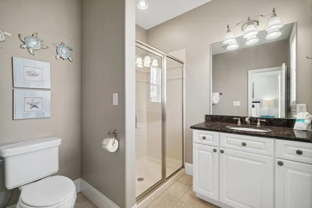 a bedroom with a bed and a flat tv screen on dresser