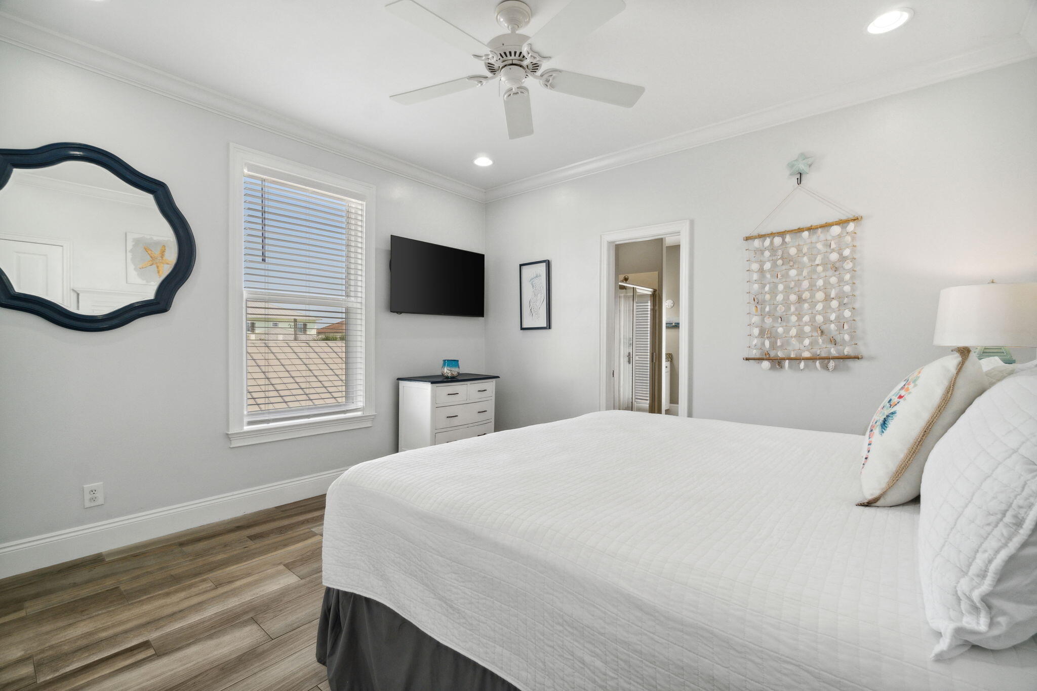 29 Sarasota Street Miramar Beach, FL 32550 - Photo 39 of 66 a bedroom with a bed a mirror and a flat tv screen on dresser