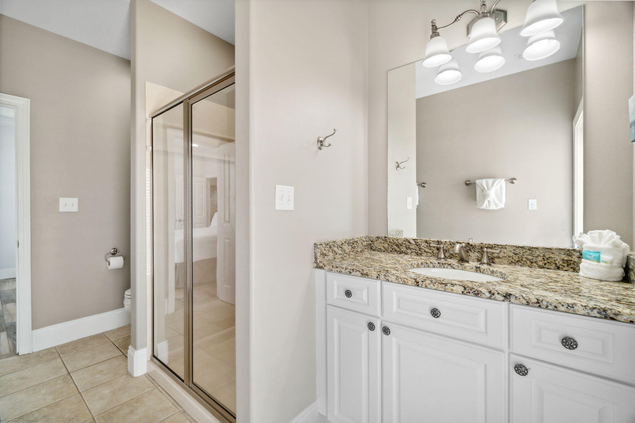 29 Sarasota Street Miramar Beach, FL 32550 - Photo 41 of 66 a bathroom with a granite countertop sink a mirror and a shower
