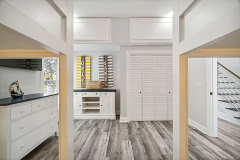 a view of a dining room with furniture wooden floor and a chandelier
