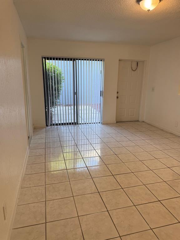 1 Crossing Circle, Unit C Boynton Beach, FL 33435 - Photo 3 of 12 a view of a livingroom with a floor to ceiling window and stairs