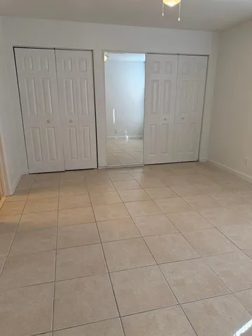 a view of a livingroom with an empty space and a window