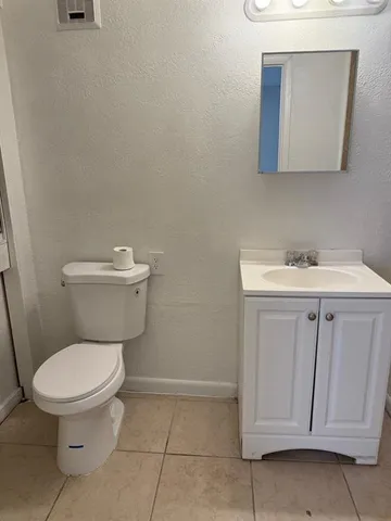 a white toilet sitting next to a bathroom sink
