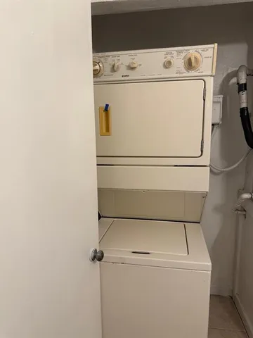 a close up view of washer and dryer with wooden floor