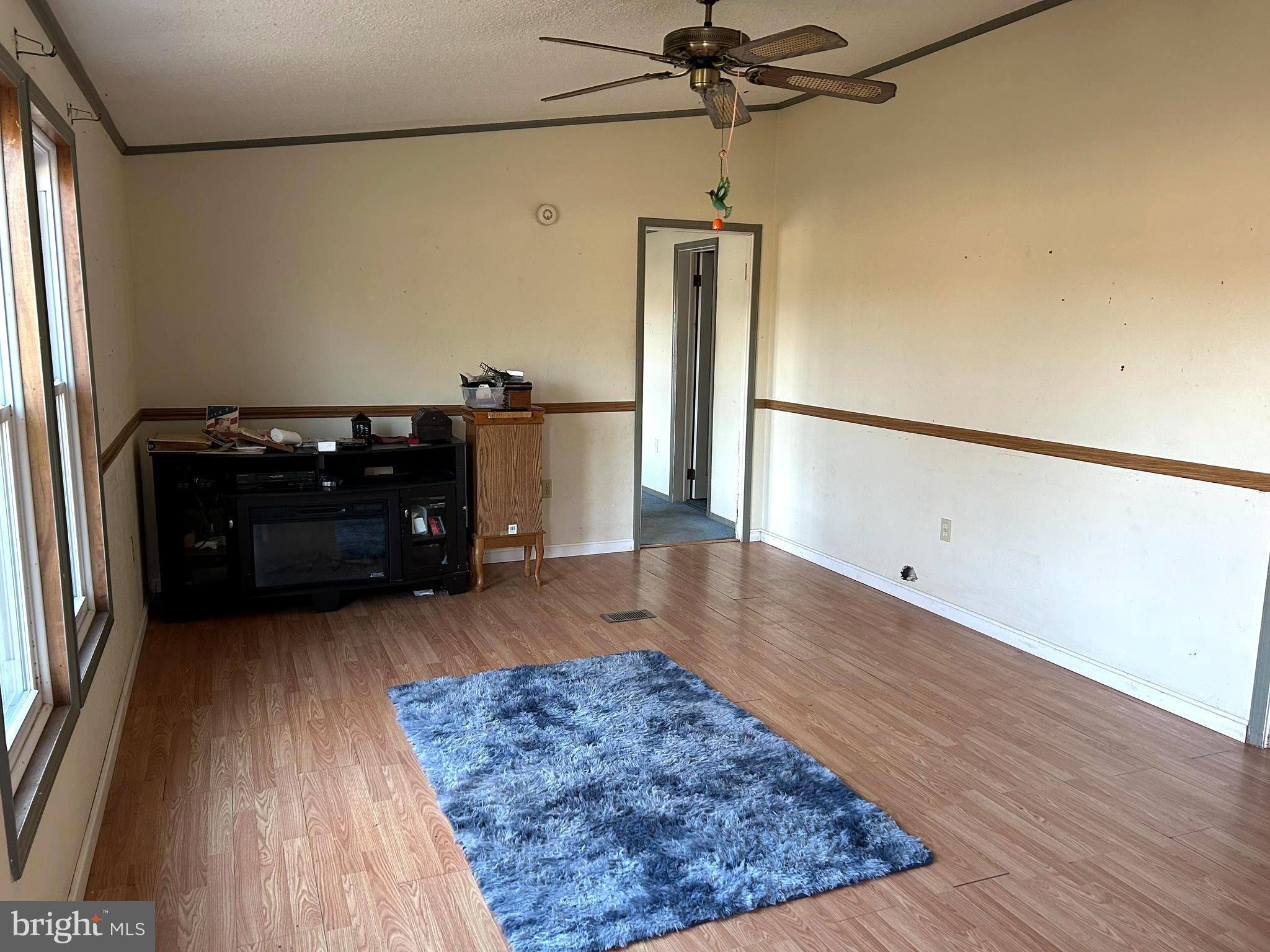 3450 Indian Bone Road Cambridge, MD 21613 - Photo 9 of 14 a living room with a couch and a chandelier