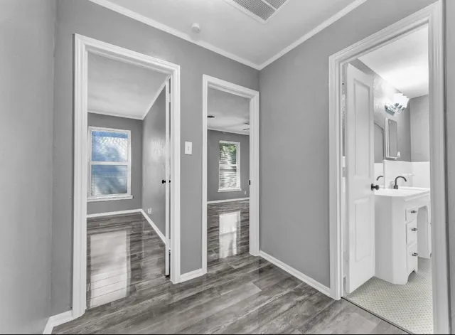 wooden floor with a bathroom and mirror