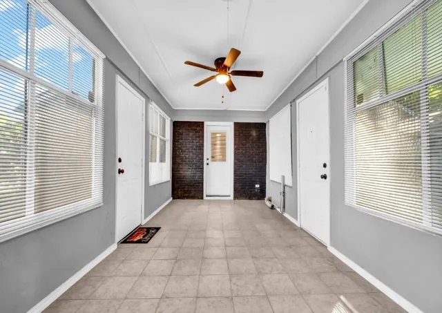 a view of a livingroom with a ceiling fan and window