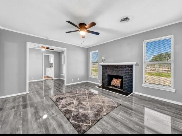 a view of a livingroom with a fireplace and window