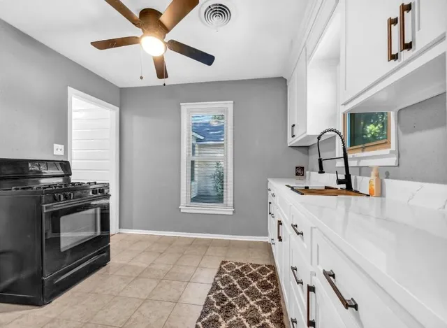a kitchen with a sink stove and microwave