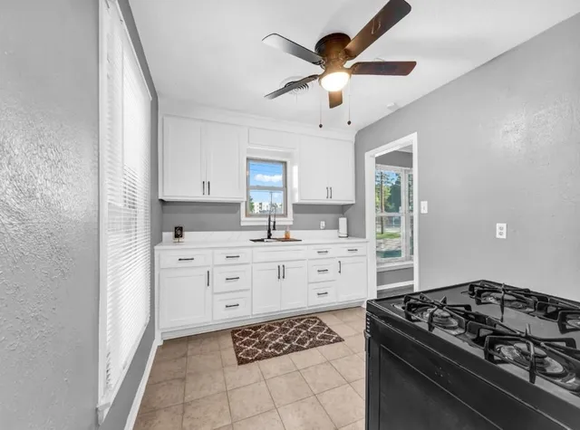 a kitchen with stainless steel appliances a stove a sink and a refrigerator