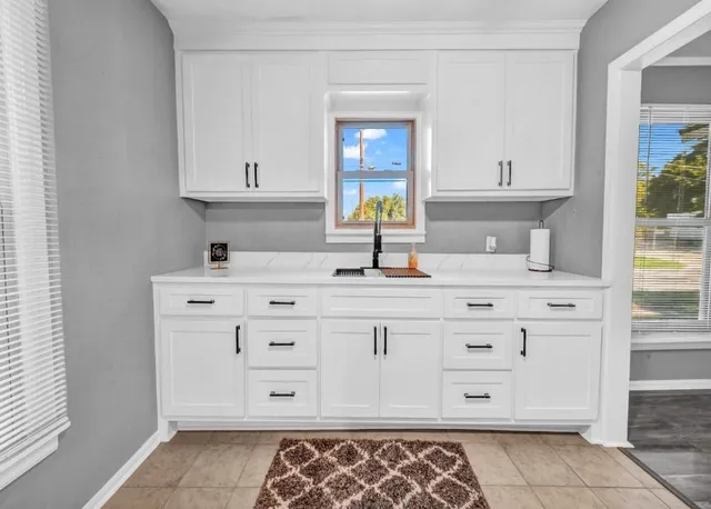 a bathroom with a sink vanity granite and a mirror