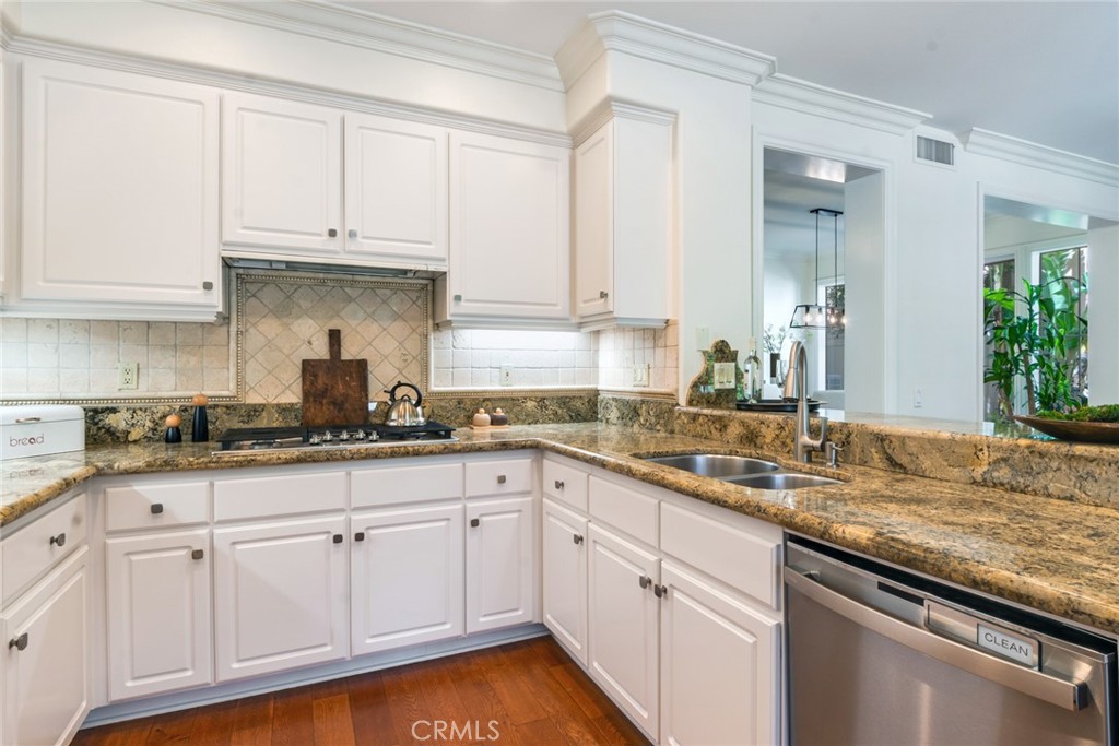 2515 Lewis Drive Tustin, CA 92782 - Photo 12 of 34 a kitchen with granite countertop white cabinets and a sink
