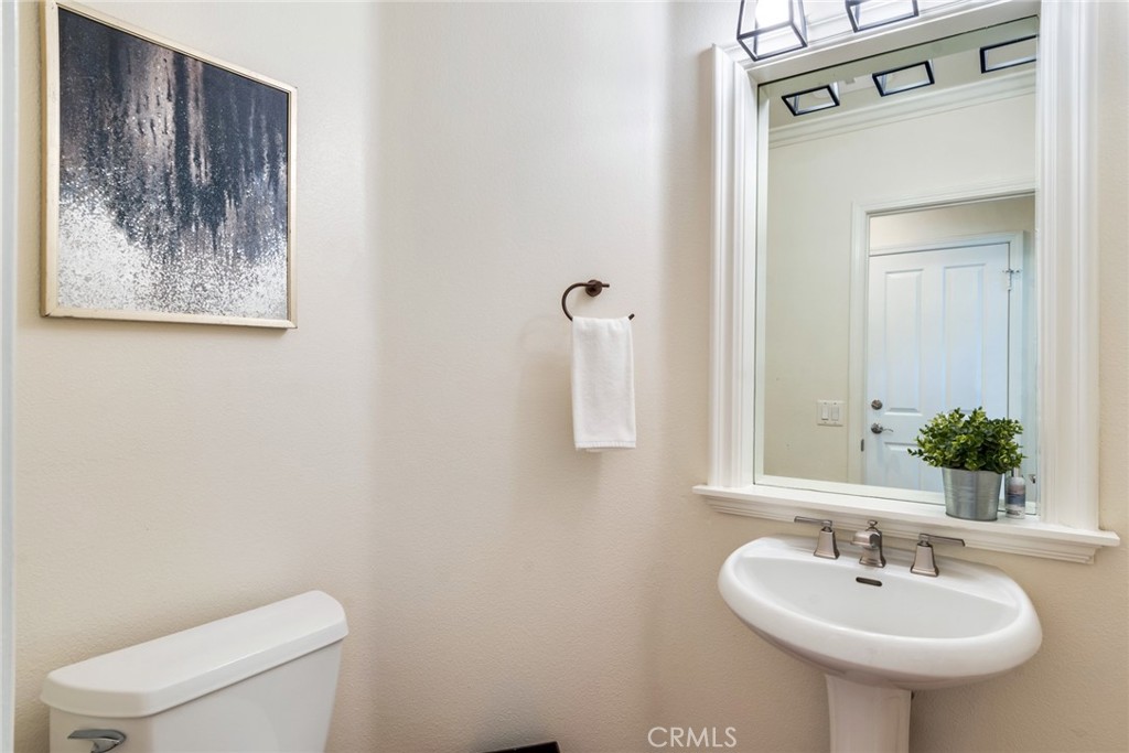 2515 Lewis Drive Tustin, CA 92782 - Photo 13 of 34 a bathroom with a toilet a sink and mirror