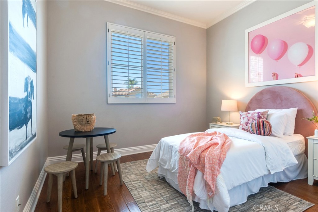 2515 Lewis Drive Tustin, CA 92782 - Photo 14 of 34 a bedroom with a bed a chair and a potted plant