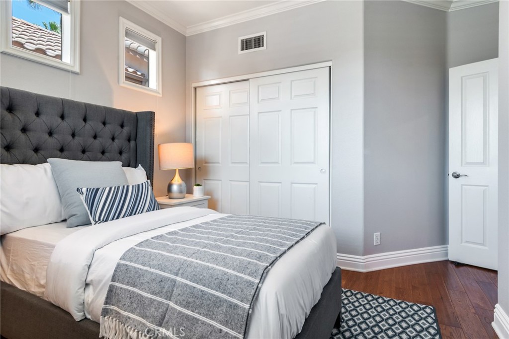 2515 Lewis Drive Tustin, CA 92782 - Photo 17 of 34 a bedroom with a bed and a window with wooden floor