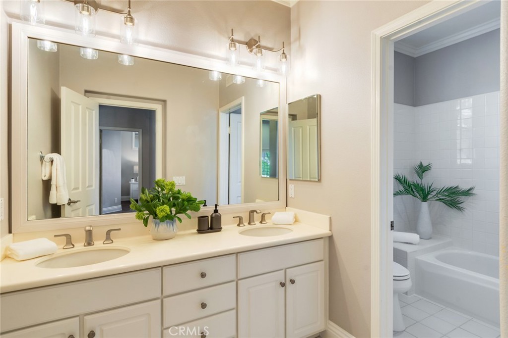 2515 Lewis Drive Tustin, CA 92782 - Photo 19 of 34 a bathroom with a tub sink and mirror
