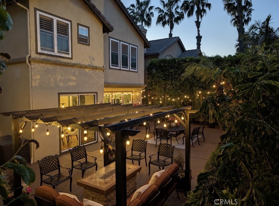 2515 Lewis Drive Tustin, CA 92782 - Photo 27 of 34 a view of a patio with table and chairs with wooden fence and plants