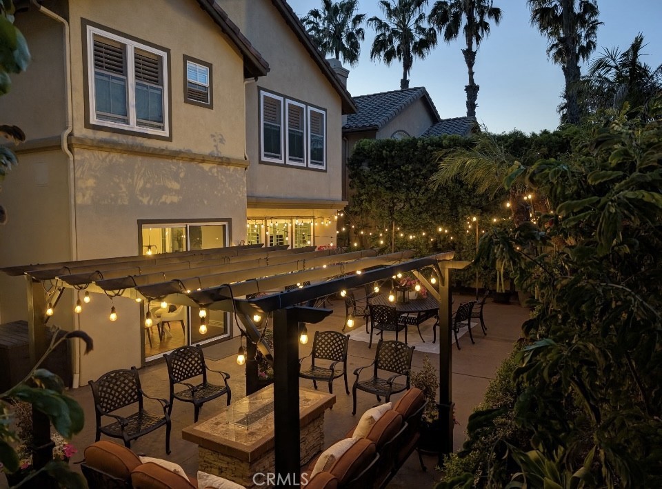 2515 Lewis Drive Tustin, CA 92782 - Photo 30 of 34 a view of a patio with table and chairs with wooden fence and plants