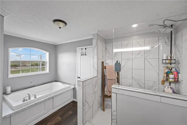 a large white kitchen with stainless steel appliances granite countertop a refrigerator and a stove