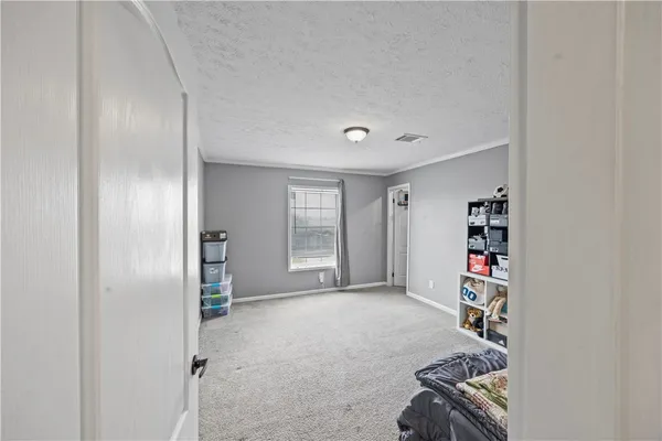 a bedroom with a bed and a ceiling fan