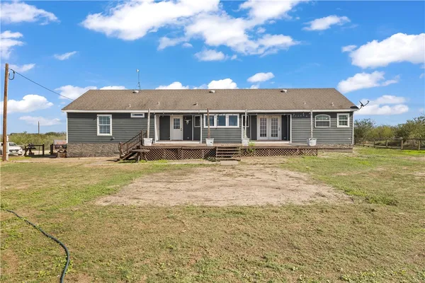 a view of a terrace with lawn chairs