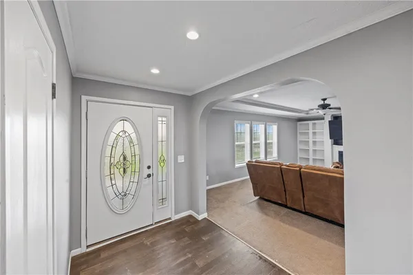 a large kitchen with kitchen island a large counter top space a sink stainless steel appliances and cabinets