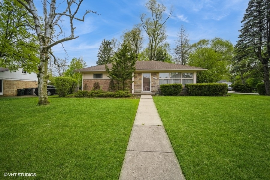 1126 Whitfield Road Northbrook, IL 60062 - Photo 1 of 14 a front view of a house with a yard and green space