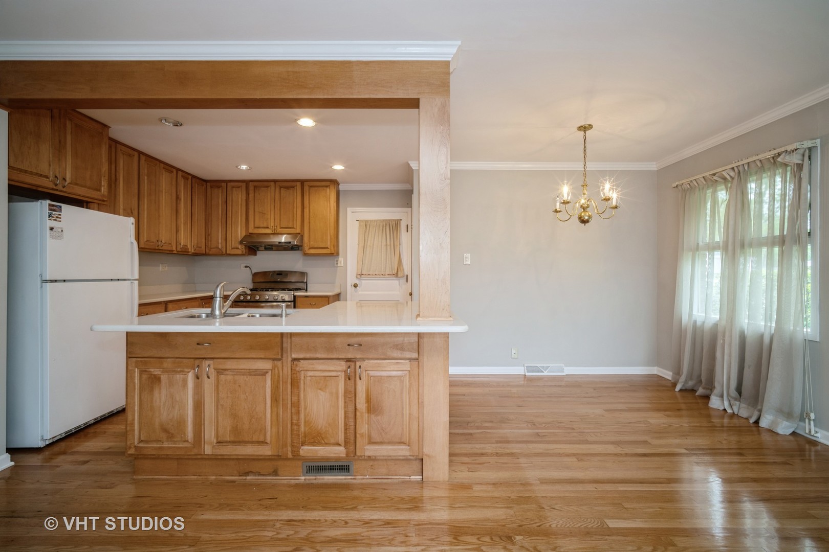 1126 Whitfield Road Northbrook, IL 60062 - Photo 3 of 14 a kitchen with kitchen island granite countertop wooden cabinets and a refrigerator