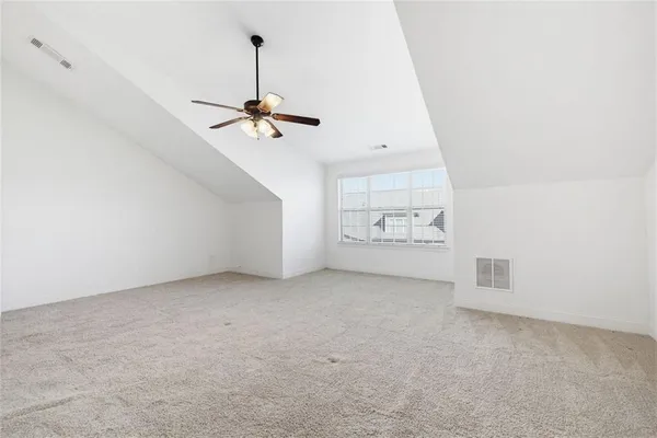 a living room with furniture a large window and a table