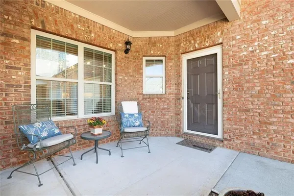 a large white kitchen with cabinets a sink a stove a dining table and chairs